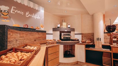 Bakery with fresh croissants and pastries on wooden counters