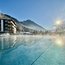 Heated outdoor pool with mountain view and clear blue winter sky