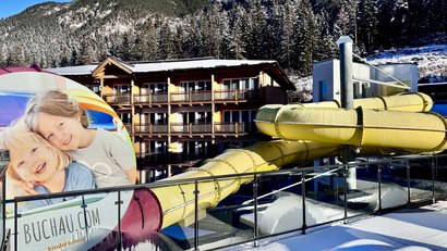 Hotel with yellow water slide and snowy mountain landscape in the background